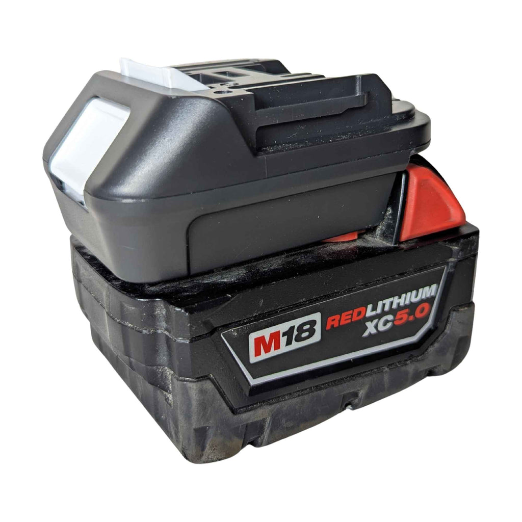 Milwaukee M18 to Makita 18V LXT battery adapter - fitted to the Milwaukee M18 battery, Makita-side rail facing up